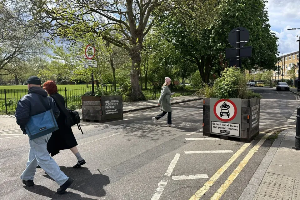Two planters block cars from going onto a low-traffic street.